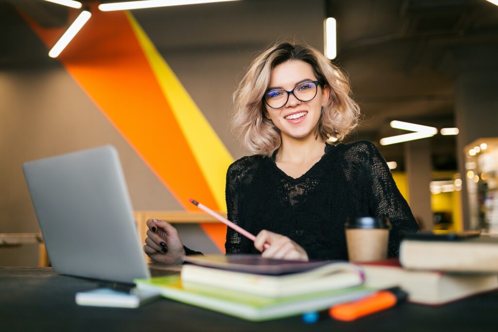 young woman working on laptop in co-working office